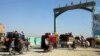 Afghans flee their villages after the fighting intensified between Taliban militants and security forces in Lashkar Gah, the provincial capital of restive Helmand Province, on October 12.