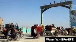 Afghans flee their villages after the fighting intensified between Taliban militants and security forces in Lashkar Gah, the provincial capital of restive Helmand Province, on October 12.