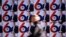 A passerby walks past election posters of the Serbian Progressive Party's (SNS) top candidate for the presidential election, Serbian Prime Minister Aleksandar Vucic, in Belgrade.