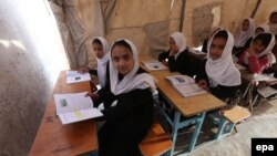 Afghan school girls attend a class at a makeshift camp in Herat in April 2015.