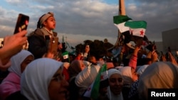 People gather during a celebration called by Hayat Tahrir al-Sham (HTS) after the ousting of Syria's Bashar al-Assad, in Damascus