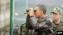  US President Barack Obama looks through binoculars toward North Korea from Observation Post Ouellette during a visit to the Joint Security Area of the Demilitarized Zone (DMZ) near Panmunjom on the border between North and South Korea.