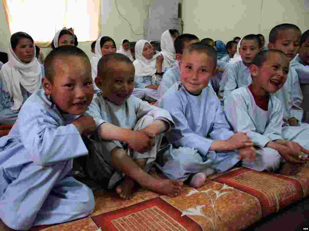 Afghan orphans prepare for lunch at an orphanage in Kabul on August 8. Despite the progress of the past few years, Afghanistan's economy remains in shambles and highly dependent on foreign aid, agriculture, and trade with neighboring countries. Photo by S. Sabawoon for epa