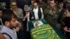 Relatives and friends gather around the coffin of Afghan reporter Zabihullah Tamanna, who was killed in a Taliban ambush in June 2016.