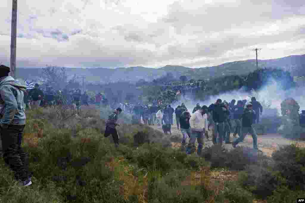 Tear gas is fired as people protest against the so-called "hotspot" being built for refugees and migrants on the Aegean island of Kos. (AFP/Eurokinissi)