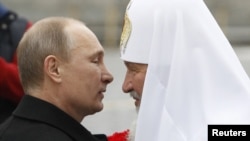 President Vladimir Putin (left) welcomes Patriarch Kirill during a ceremony to mark National Unity Day in Moscow on November 4.