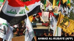 Mourners surround a car carrying the coffin of Iraqi paramilitary chief Abu Mahdi al-Muhandis during a funeral procession, for him and nine others, in Baghdad's district of al-Jadriya, near the high-security Green Zone. January 4, 2020