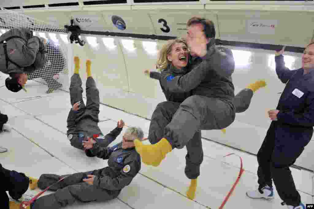 Civilian passengers of France&#39;s Airbus A330 Zero-G, who are not astronauts or scientists, enjoy weightlessness during the first zero-gravity flight for paying passengers in Europe. All boarding cards, costing 6,000 euros, were sold for the years 2013 and 2014. Zero gravity is simulated by flying a series of parabolic flight maneuvers. (AFP/Mehdi Fedouach)