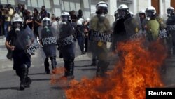 Gresiýanyň polisiýasy daş böleklerini oklan we benzinli bomba ulanan protestçilere garşy göz ýaşardyjy gazy we burçly suw pürküjini ulandy.