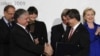 Switzerland -- Turkish Foreign Minister Ahmet Davutoglu (2ndR) and Armenian Foreign Minister Eduard Nalbandiana (2nd L) shake hands as they hold signed documents after a signing ceremony in front of (L to R) European Union foreign affairs chief Javier Sol