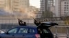 Ukrainian police officers shoot at a drone during a Russian attack in Kyiv on October 17.