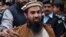 Pakistani security personnel escort Zaki-ur-Rehman Lakhvi, alleged mastermind of the 2008 Mumbai attacks, as he leaves court after a hearing in Islamabad on January 1, 2015.