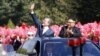 NOTRH KOREA - North Korean leader Kim Jong Un (right) and South Korean President Moon Jae-in (left) wave to Pyongyang citizens from an open-topped as they drive through Pyongyang on September 18, 2018