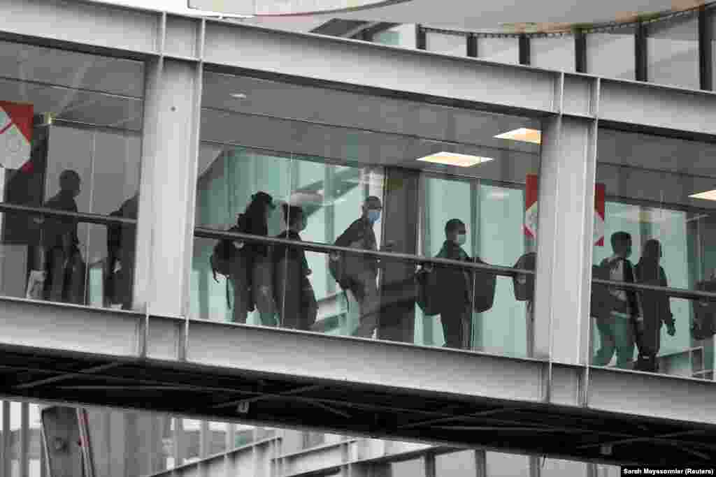 People evacuated from Afghanistan arrive at Charles de Gaulle airport in Paris on August 17.