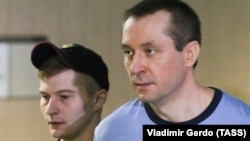 Russian ex-police Colonel Dmitry Zakharchenko (right) attends a court hearing in Moscow on May 15. 