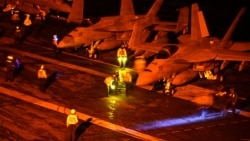 Photo provided by the US Navy shows F/A-18 jets ready for launch, part of Washington's efforts to keep the Strait of Hormuz open.