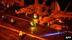 Photo provided by the US Navy shows F/A-18 jets ready for launch, part of Washington's efforts to keep the Strait of Hormuz open.