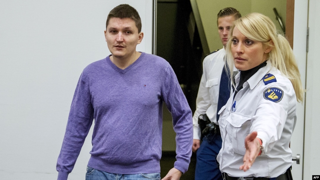 Vladimir Drinkman is escorted by police officers to a hearing at The Hague in 2015. He was a key member of a criminal hacking group that penetrated Heartland Payment Systems, an attack ranked as one of the biggest data breaches of all time.