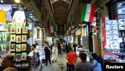 Shoppers walk through Tehran’s Grand Bazaar on April 13.