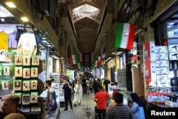 Shoppers walk through Tehran’s Grand Bazaar on April 13.