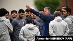 Iran's Portuguese soccer coach Carlos Queiroz gestures as he talks to his team.