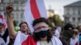 TOPSHOT - A protester wears a white-red-white bandage on the eyeline during the 'Freedom March for Belarus' in Warsaw, Poland, August 9, 2025.