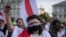 TOPSHOT - A protester wears a white-red-white bandage on the eyeline during the 'Freedom March for Belarus' in Warsaw, Poland, August 9, 2025.