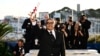 Iranian director and producer Mohammad Rasoulof poses during a photocall after he won the a Special Jury Prize for the film "The Seed of the Sacred Fig" during the Closing Ceremony at the 77th edition of the Cannes Film Festival in Cannes, southern France