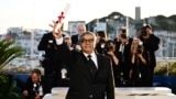 Iranian director and producer Mohammad Rasoulof poses during a photocall after he won the a Special Jury Prize for the film "The Seed of the Sacred Fig" during the Closing Ceremony at the 77th edition of the Cannes Film Festival in Cannes, southern France