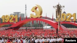 China - Participants wave national and party flags before the event marking the 100th founding anniversary of the Communist Party of China, on Tiananmen Square in Beijing, July 1, 2021. 