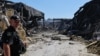 A police officer walks at the site of a shopping mall damaged following a Russian strike in Kryviy Rih on August 22.