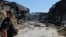 A police officer walks at the site of a shopping mall damaged following a Russian strike in Kryviy Rih on August 22.