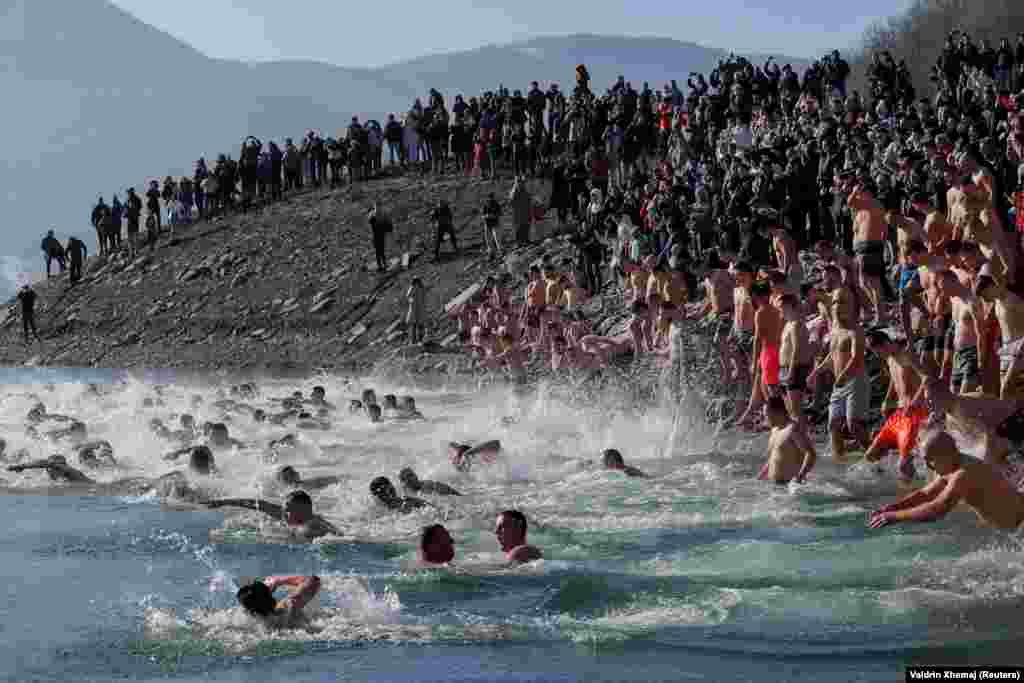 Ethnic Serbs take part in the traditional Epiphany swimming competition in Gazivoda, Kosovo.