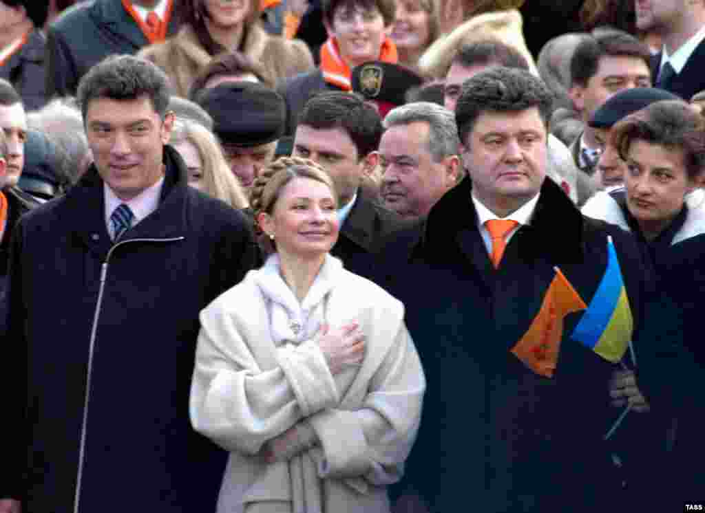 Nemtsov talks to Yulia Tymoshenko at the inauguration of Ukrainian President Viktor Yushchenko in 2005. She is also standing next to businessman Petro Poroshenko, who became president of Ukraine.