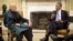 U.S. President Barack Obama (right) meets with his Afghan counterpart, Hamid Karzai, in the Oval Office of the White House in Washington on January 11.