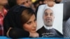 A supporter of Hassan Rohani holds a campaign poster of the candidate during a rally in Ahvaz in western Iran.