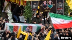 People carry the coffin of Razi Mousavi during his funeral in Tehran on December 28.