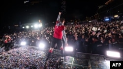 Georgian national team forward Budu Zivzivadze celebrates with fans after the team won the UEFA EURO 2024 qualifying playoff final against Greece in Tbilisi on March 27.
