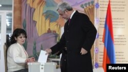 Armenian President Serzh Sarkisin casts his ballot during a referendum on constitutional changes in Yerevan on December 6. The proposals were passed with a large majority, but opposition groups say the vote was rigged. 