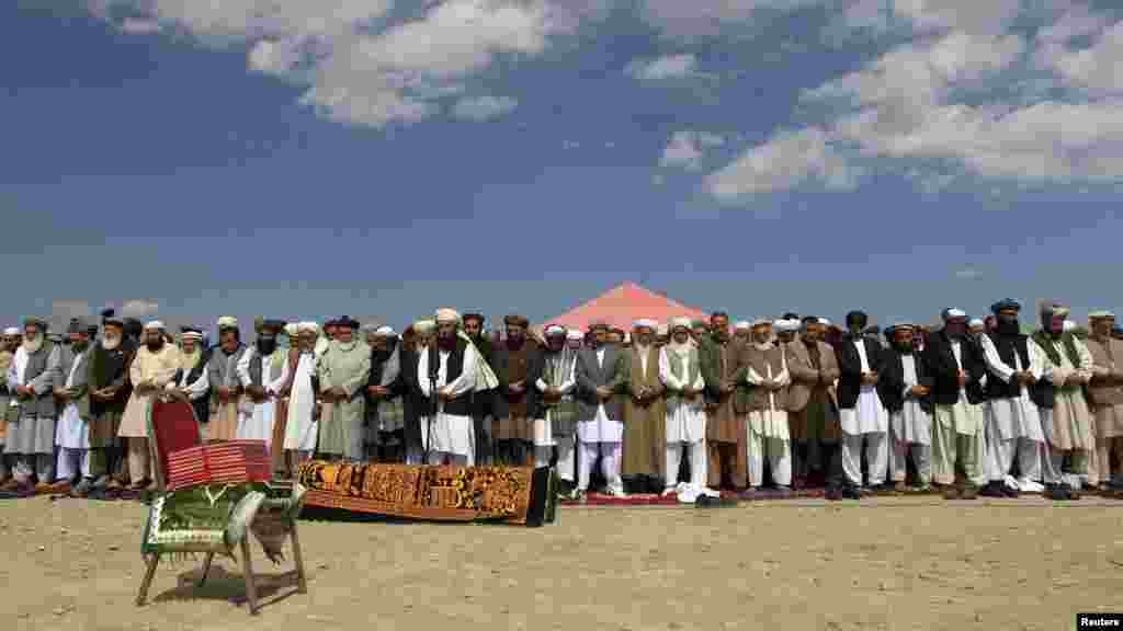 Officials and mourners perform funeral prayers over the coffin of former Taliban minister Maulvi Arsala Rahmani, a senior member of the Afghan High Peace Council, in Kabul. (Reuters/Mohammad Ismail)