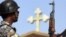 Iraq -- A policeman stands guard outside a church in the Baghdad district of Dora, 14Oct2008