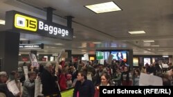 Demonstrators protest President Donald Trump's travel ban at Dulles airport on January 30.