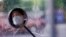 A man wearing a face mask is seen, reflected in his electric bike's rearview mirror, on a street after the lockdown was lifted in Wuhan, capital of Hubei province and China's epicentre of the novel coronavirus disease (COVID-19) outbreak