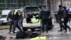 Police investigate the scene after an Afghan asylum seeker drove a car into a crowd in Munich, injuring 28 people. 