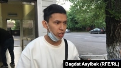 Temirlan Ensebek talks to reporters outside a police station in Almaty on May 15.
