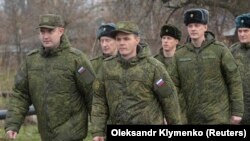 Russian military officers serving at the Joint Center for Control and Coordination (JCCC) march in the town of Soledar, Ukraine, on December 17.