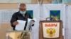 RUSSIA -- A man casts his ballots at the last day of a three-day long parliamentary elections in the far eastern city of Vladivostok, Russia September 19, 2021.