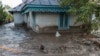 ROMANIA -- A man is pulled by locals and rescuers through flood water, after heavy rain triggered flooding in Slobozia Conachi, Galati country, Romania, September 14, 2024.