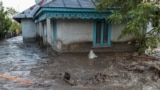 ROMANIA -- A man is pulled by locals and rescuers through flood water, after heavy rain triggered flooding in Slobozia Conachi, Galati country, Romania, September 14, 2024.