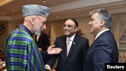 Presidents Hamid Karzai of Afghanistan, Asif Ali Zardari of Pakistan, and Abdullah Gul of Turkey (left to right) chat during a dinner at the Presidential Palace of Cankaya in Ankara.